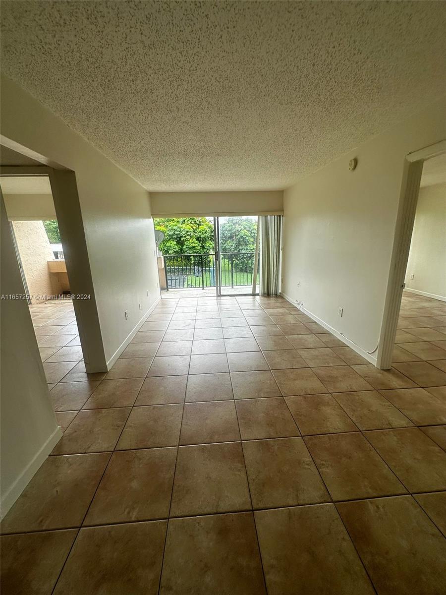 a view of a livingroom with an empty space and window