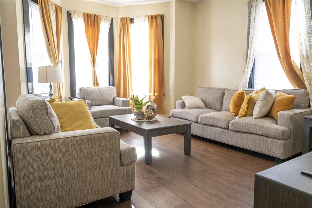 a living room with furniture and a large window