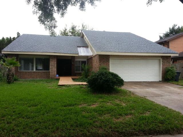 a front view of a house with a garden and yard