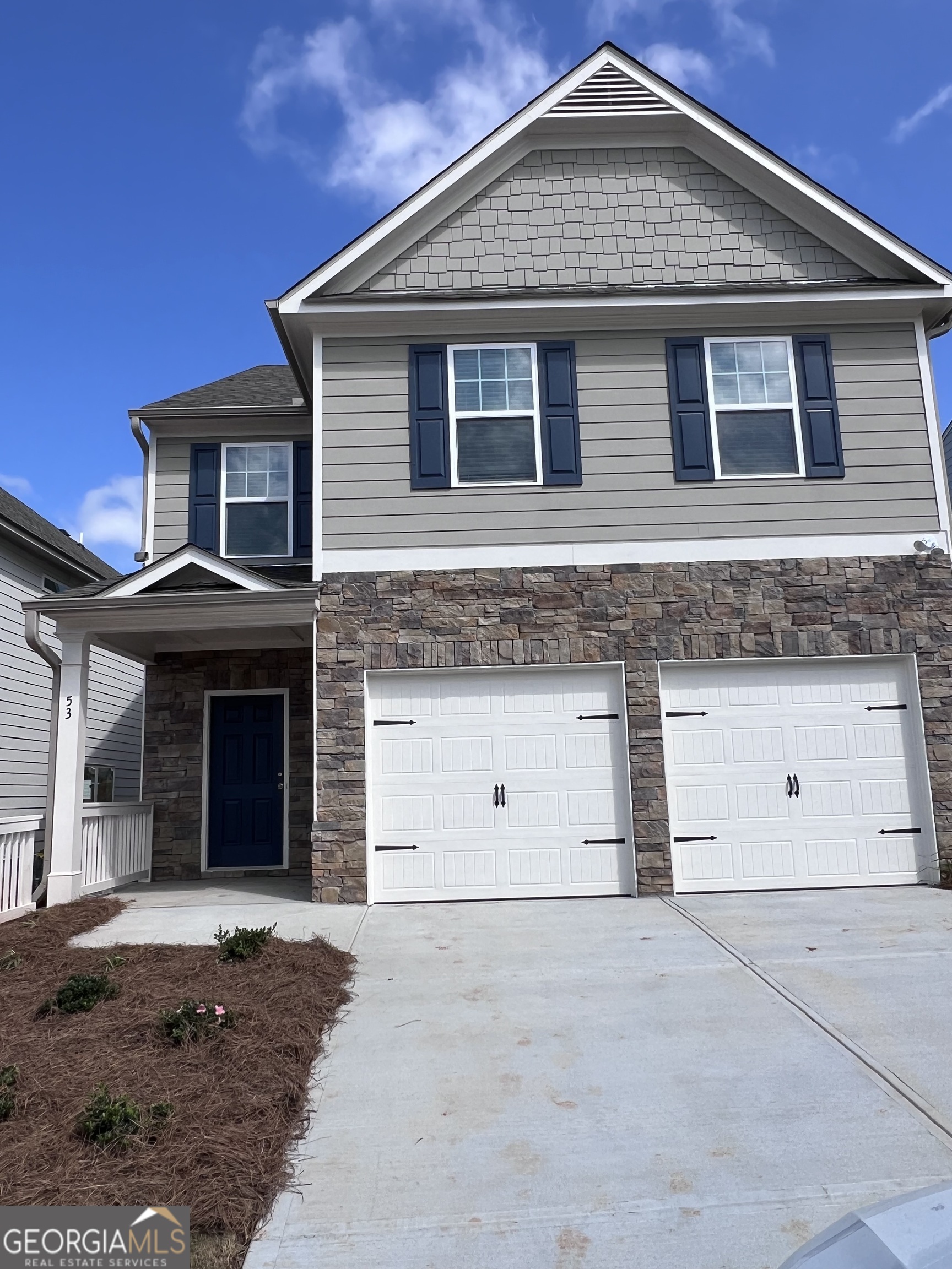 a front view of a house with a garage