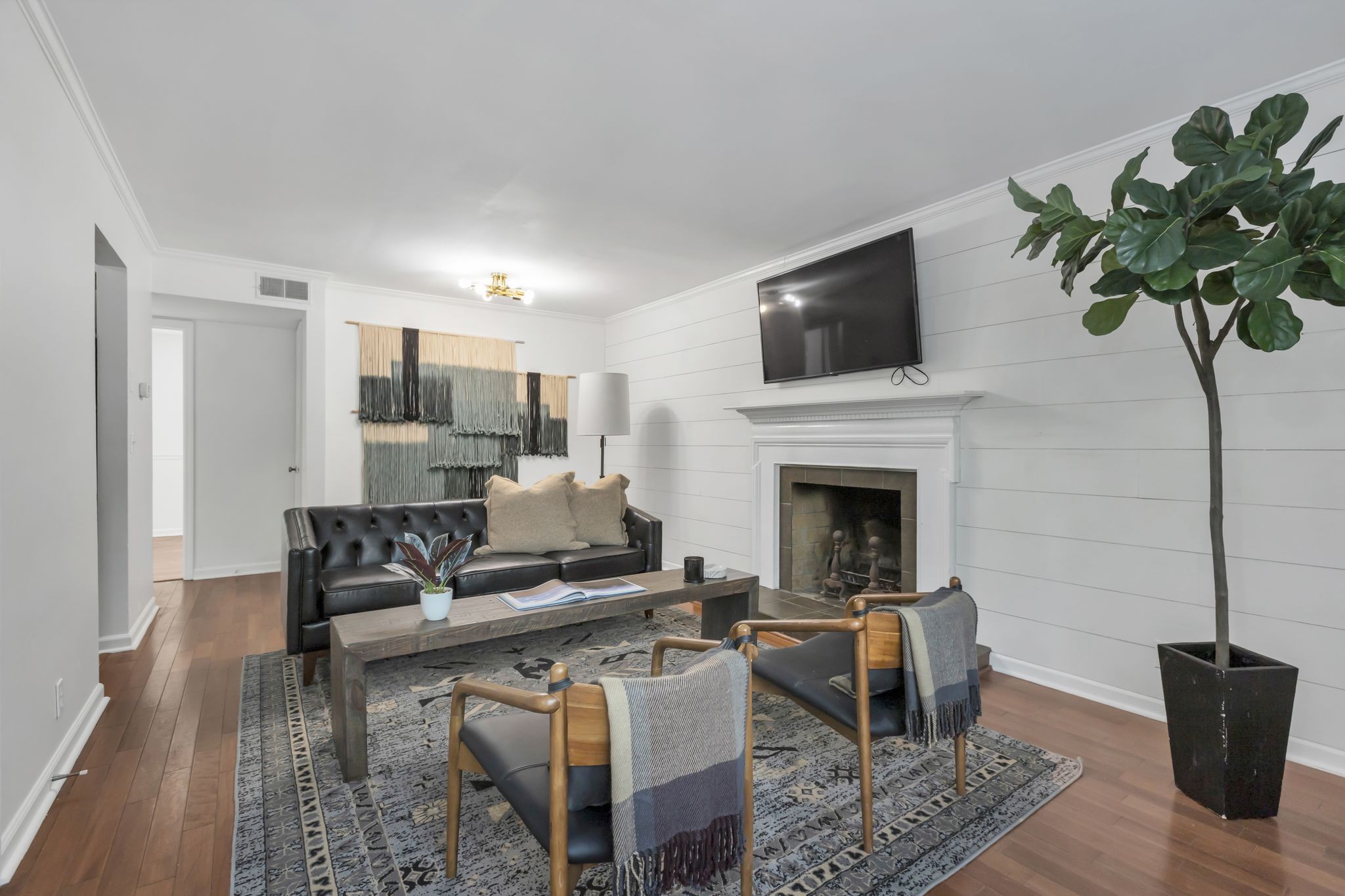 a living room with furniture a fireplace and a flat screen tv