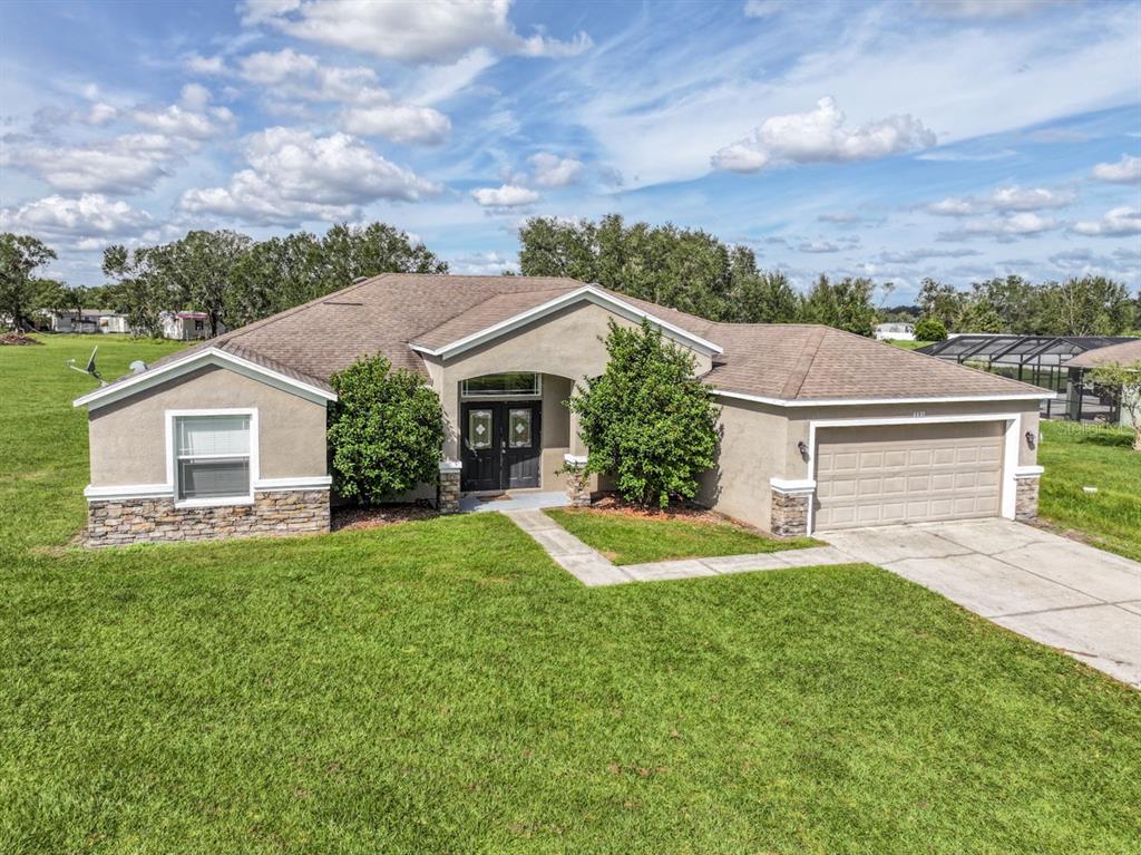 a front view of a house with a yard and garage