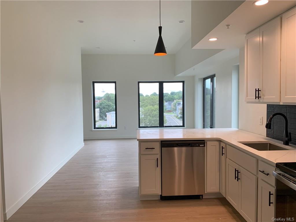 a kitchen with stainless steel appliances granite countertop a sink and a stove