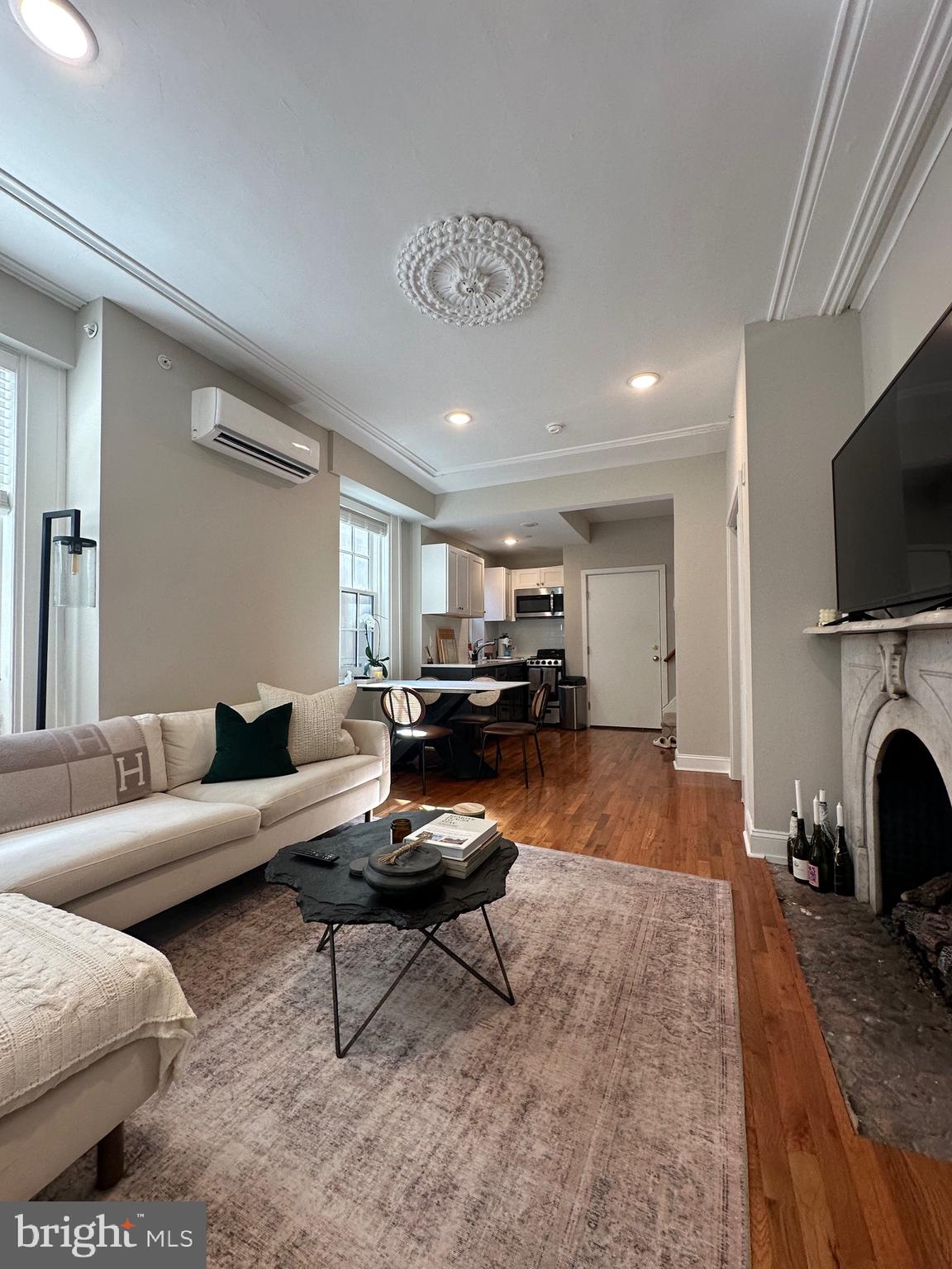 a living room with furniture and a fireplace