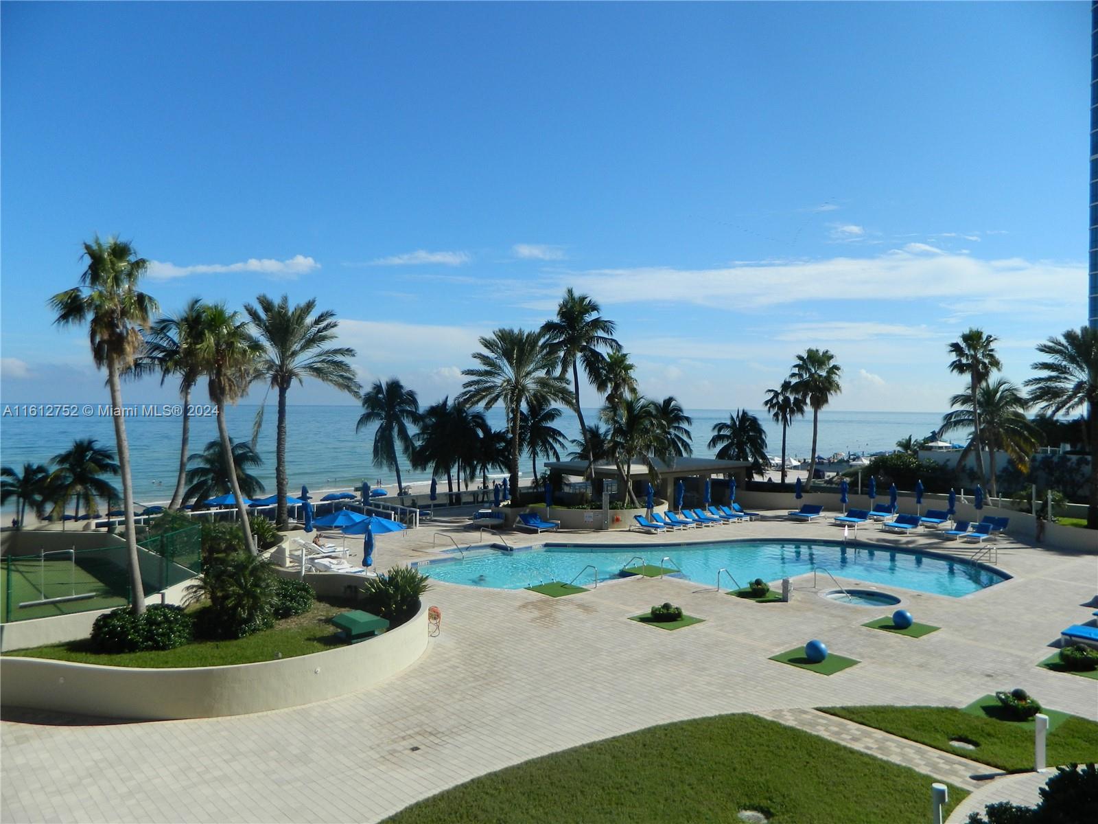 a view of a swimming pool and lounge chair