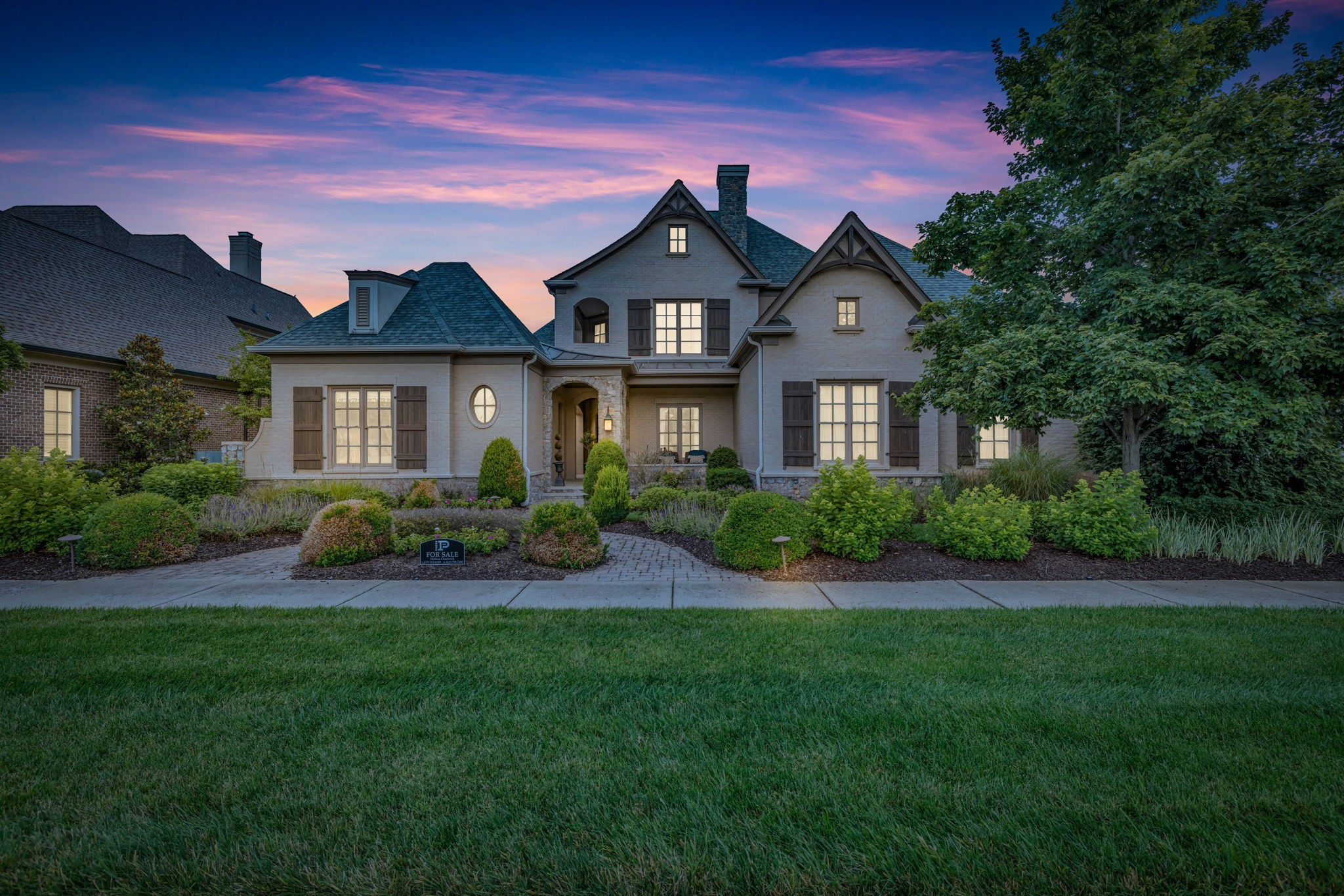 a front view of a house with a garden