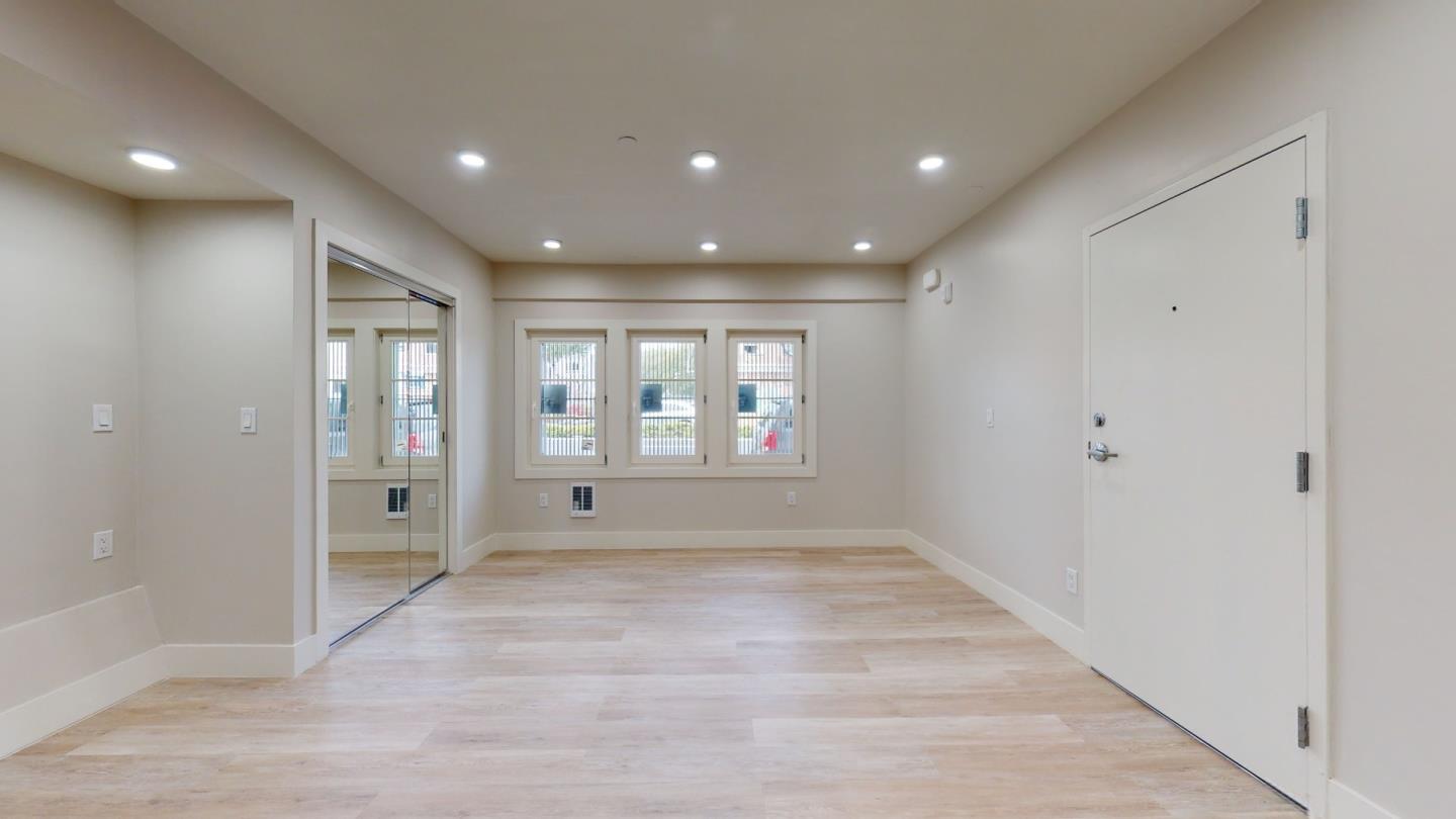 a view of an empty room with glass door