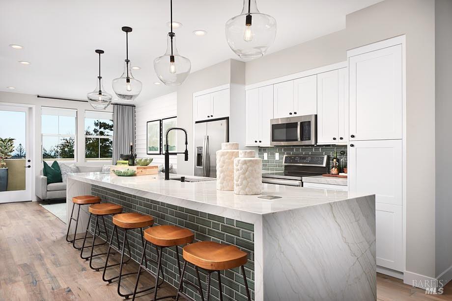 a large kitchen with a table chairs and flat screen tv