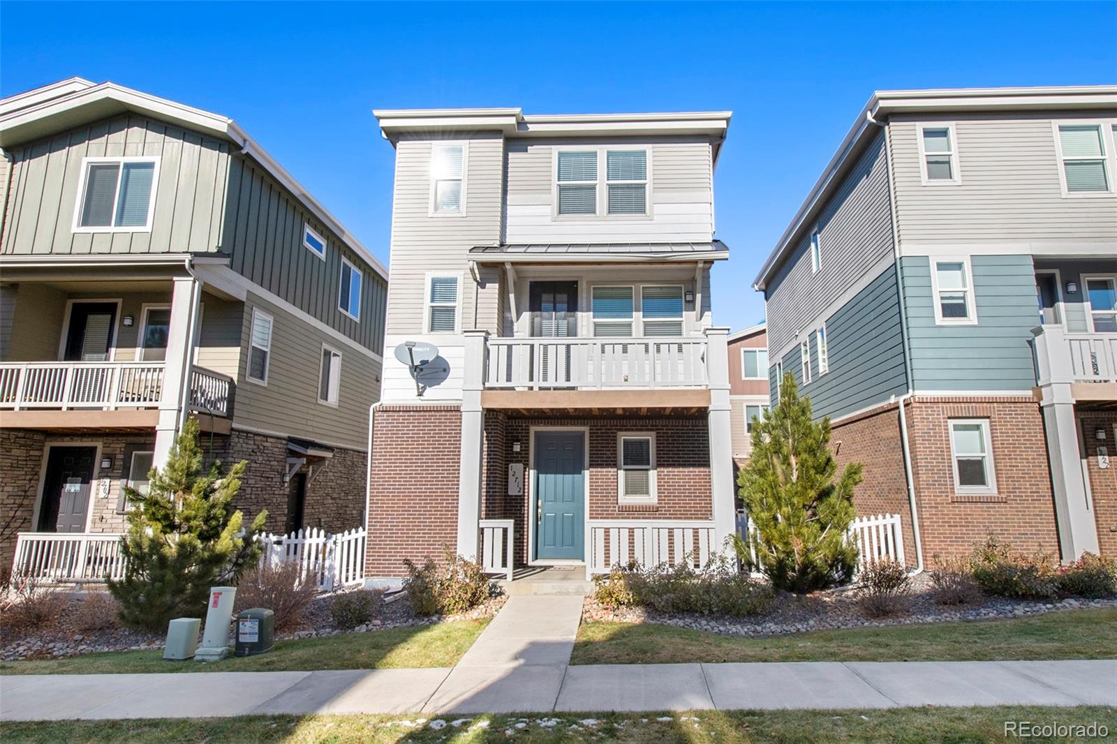 a front view of a residential apartment building with a yard