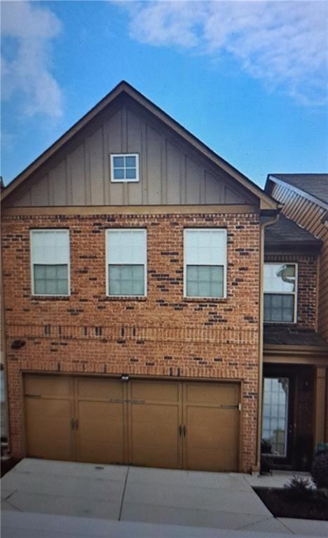 a front view of a house with garage