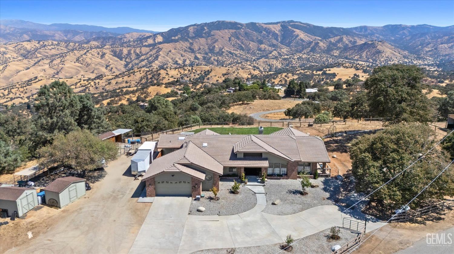 an aerial view of a house with a mountain