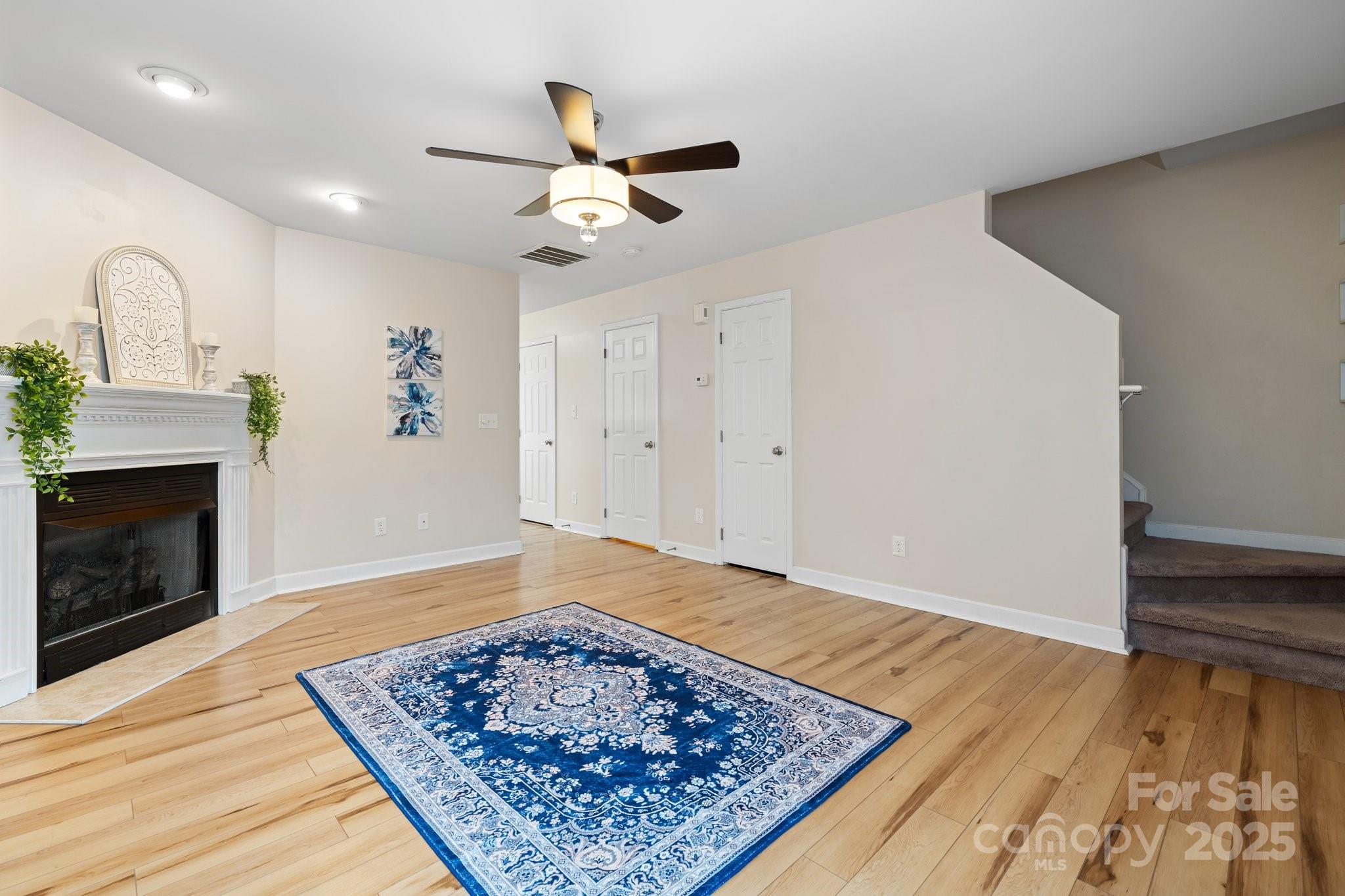 a view of a hallway with wooden floor and a fireplace