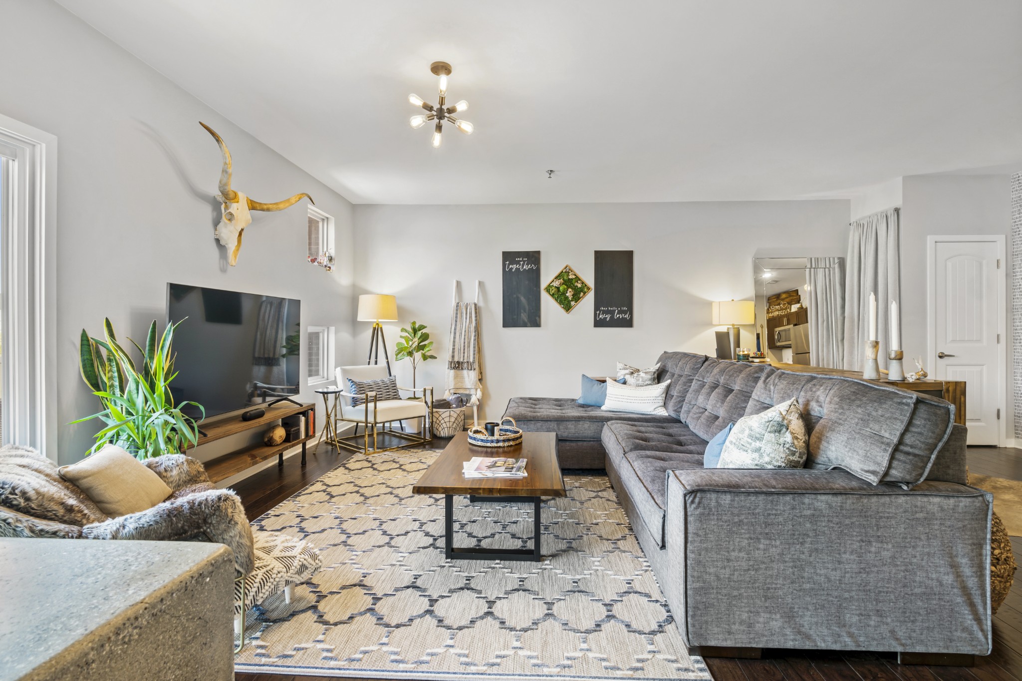 a living room with furniture and a flat screen tv