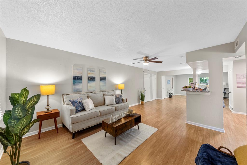 a living room with furniture and a wooden floor