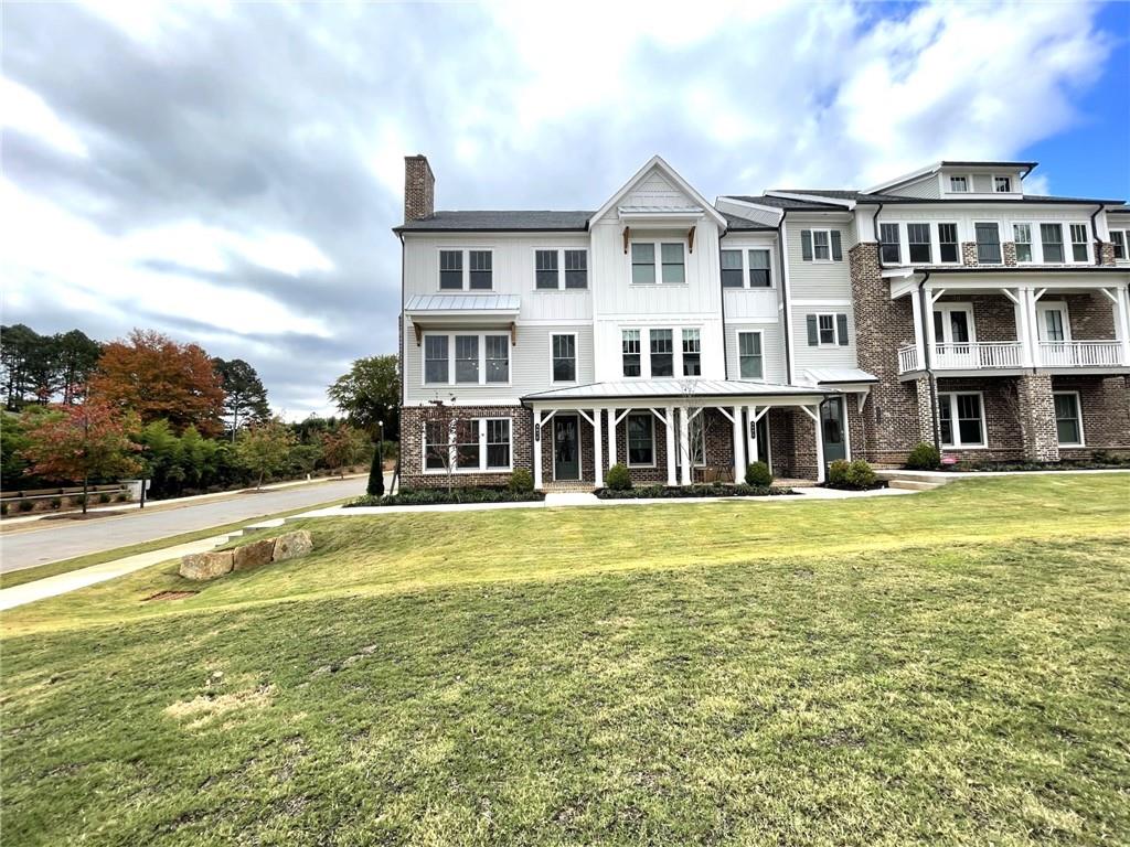 a view of a large building with a big yard and large trees