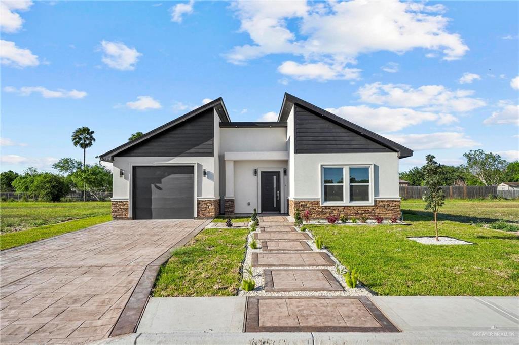 a front view of house with yard and green space