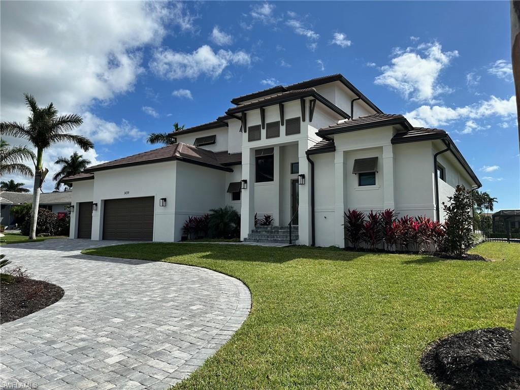 a front view of a house with a yard and garage