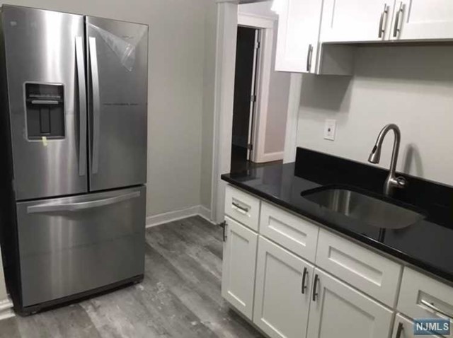 a kitchen with stainless steel appliances a refrigerator and a sink