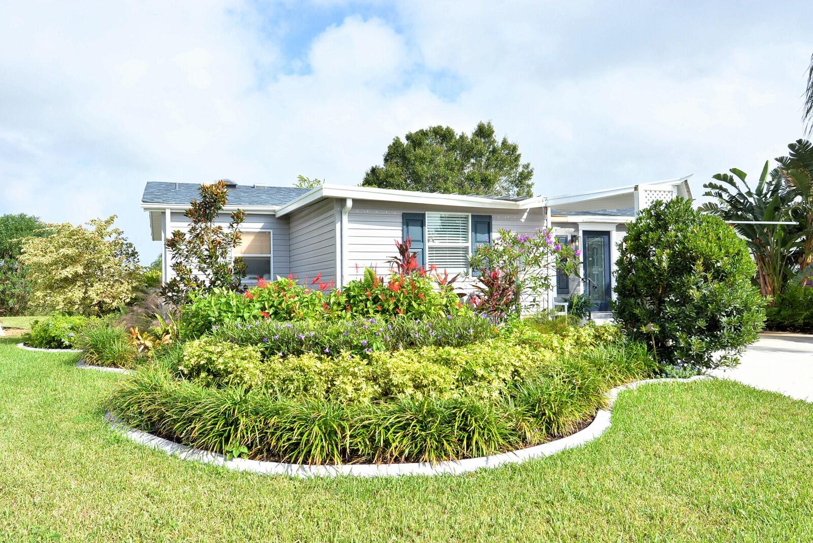 a view of a house with a yard and plants