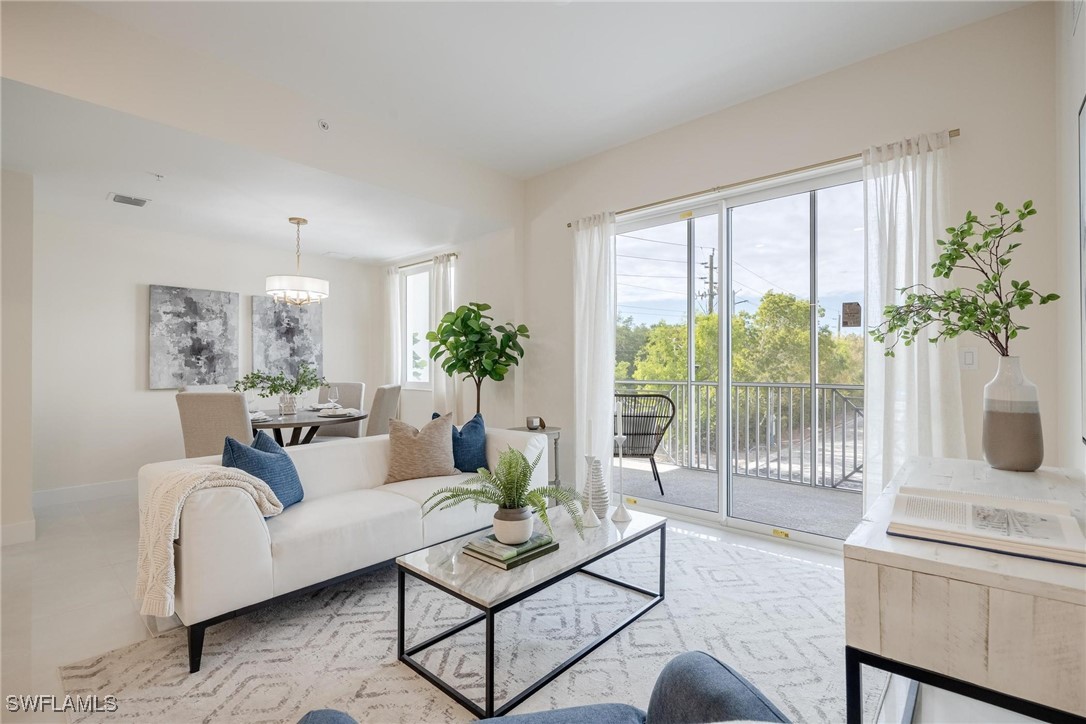 a living room with furniture and a potted plant