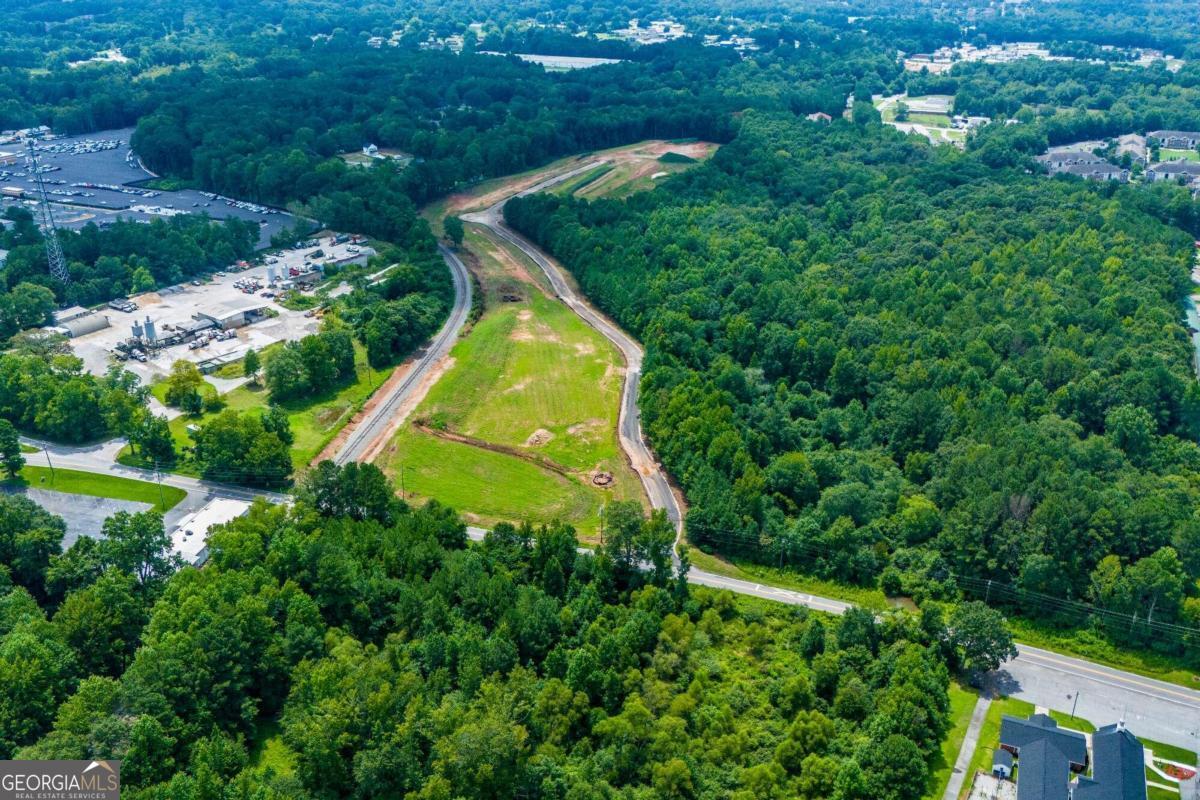 an aerial view of a house with a yard and lake view