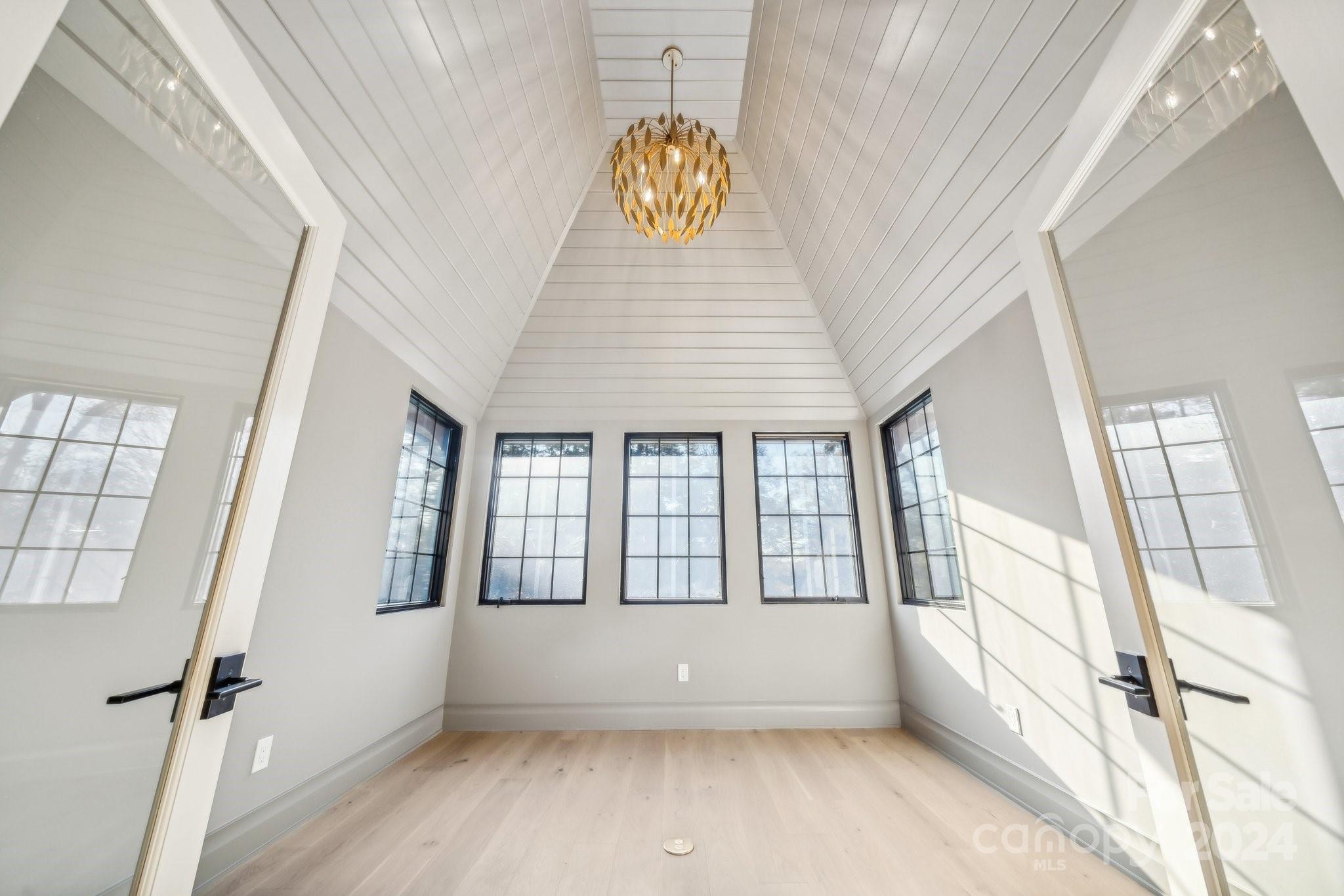 a view of an entryway with wooden floor