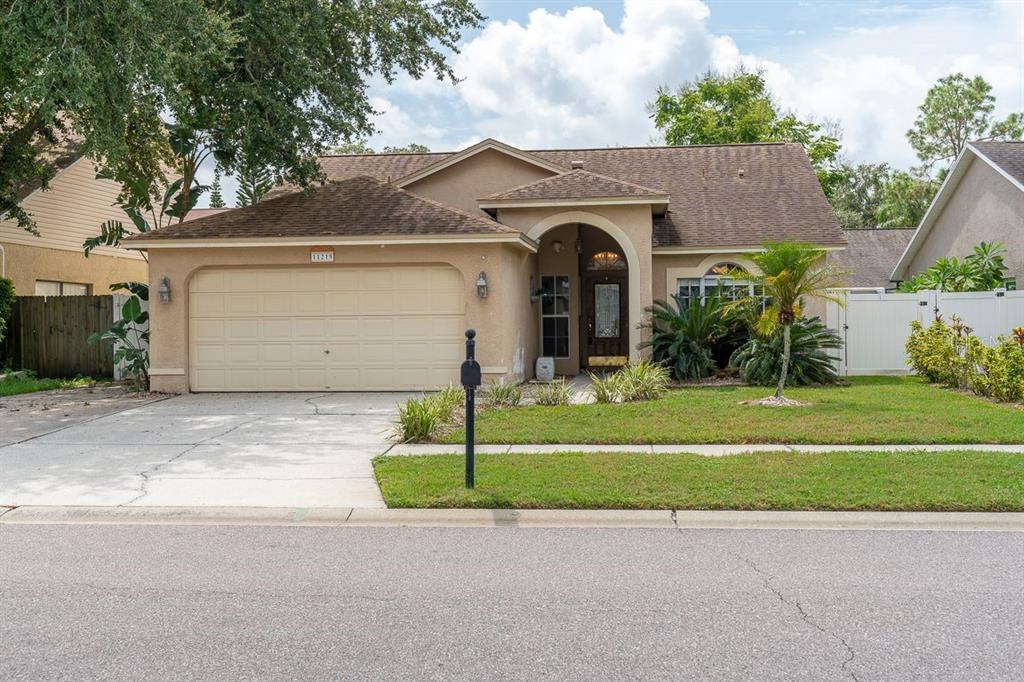 a front view of a house with a garden and garage