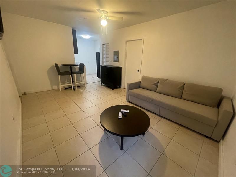 a living room with furniture and a rug