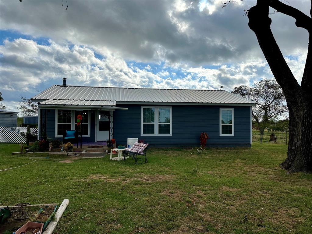 a view of a house with a yard porch and sitting area