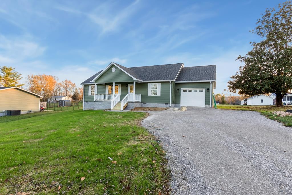 a front view of a house with a yard and garage