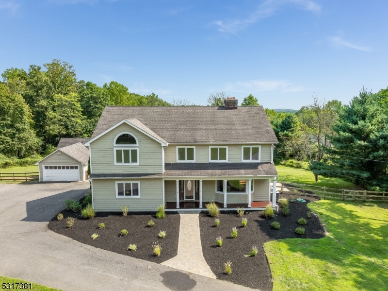 a front view of a house with yard patio and green space