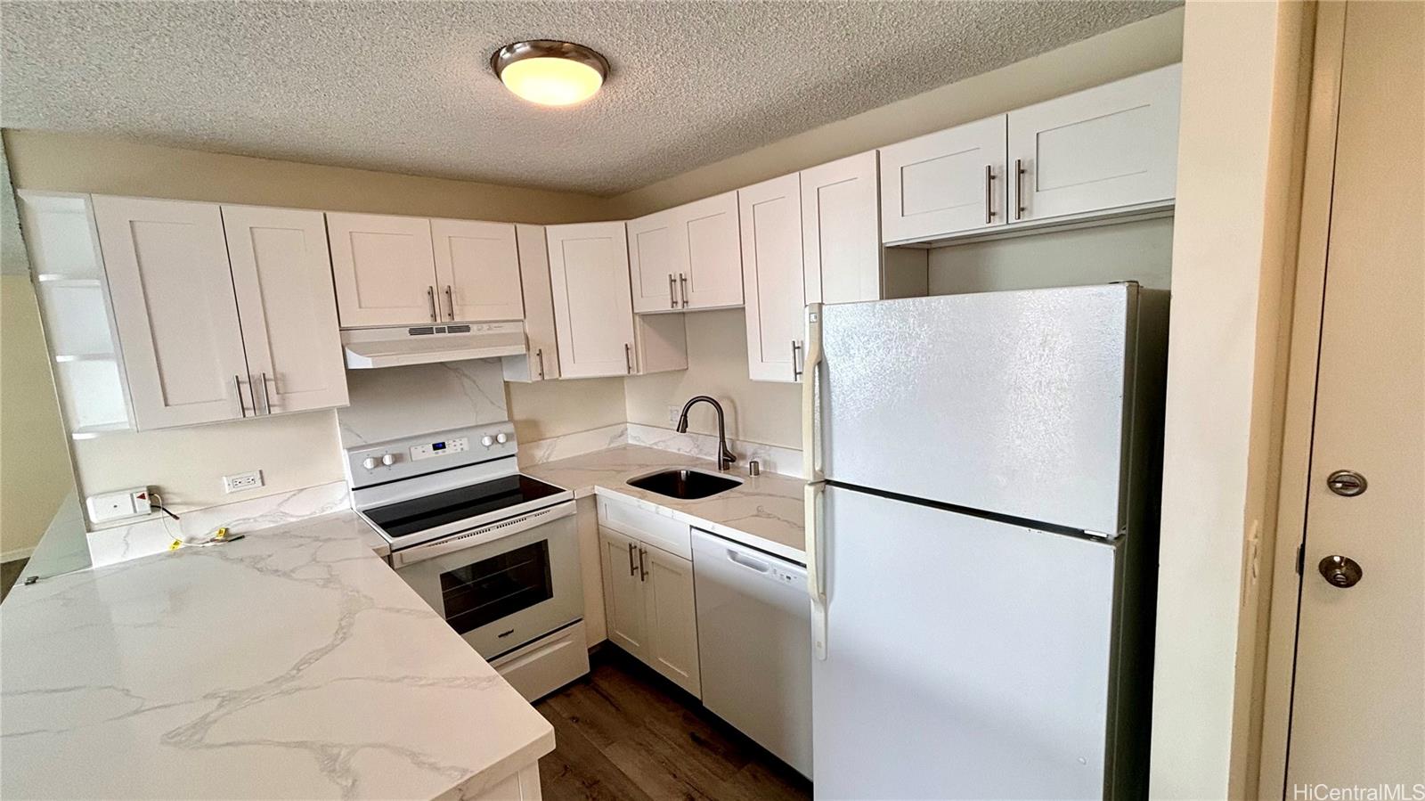 a kitchen with stainless steel appliances a refrigerator sink and cabinets