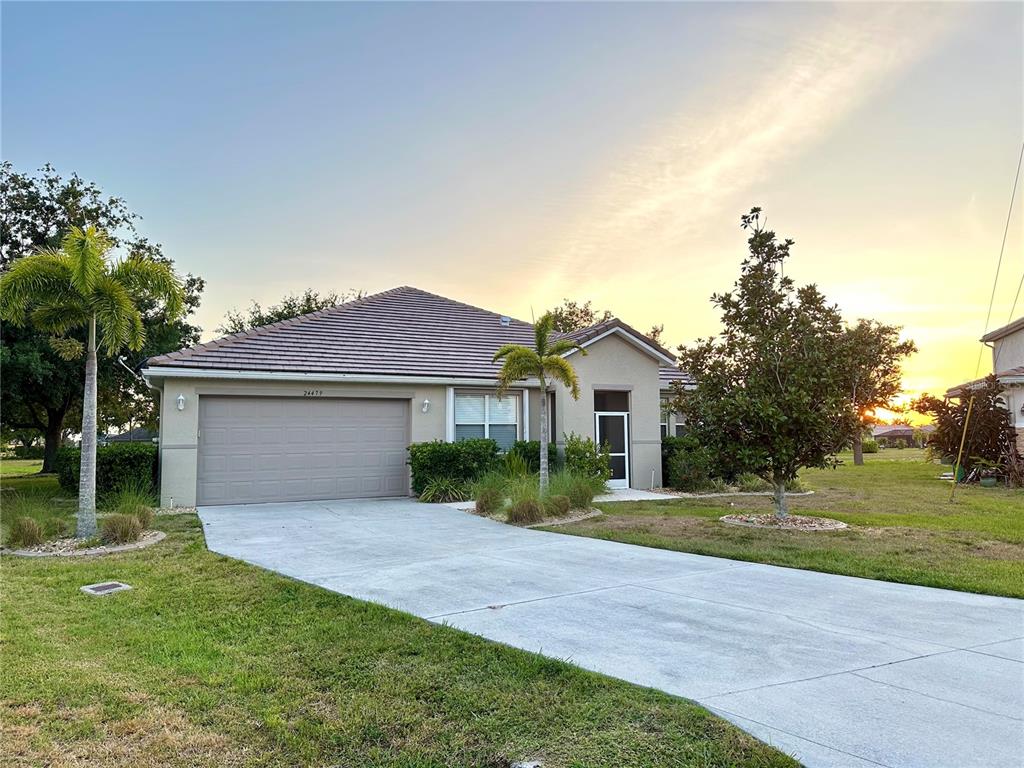 a front view of a house with a yard and garage