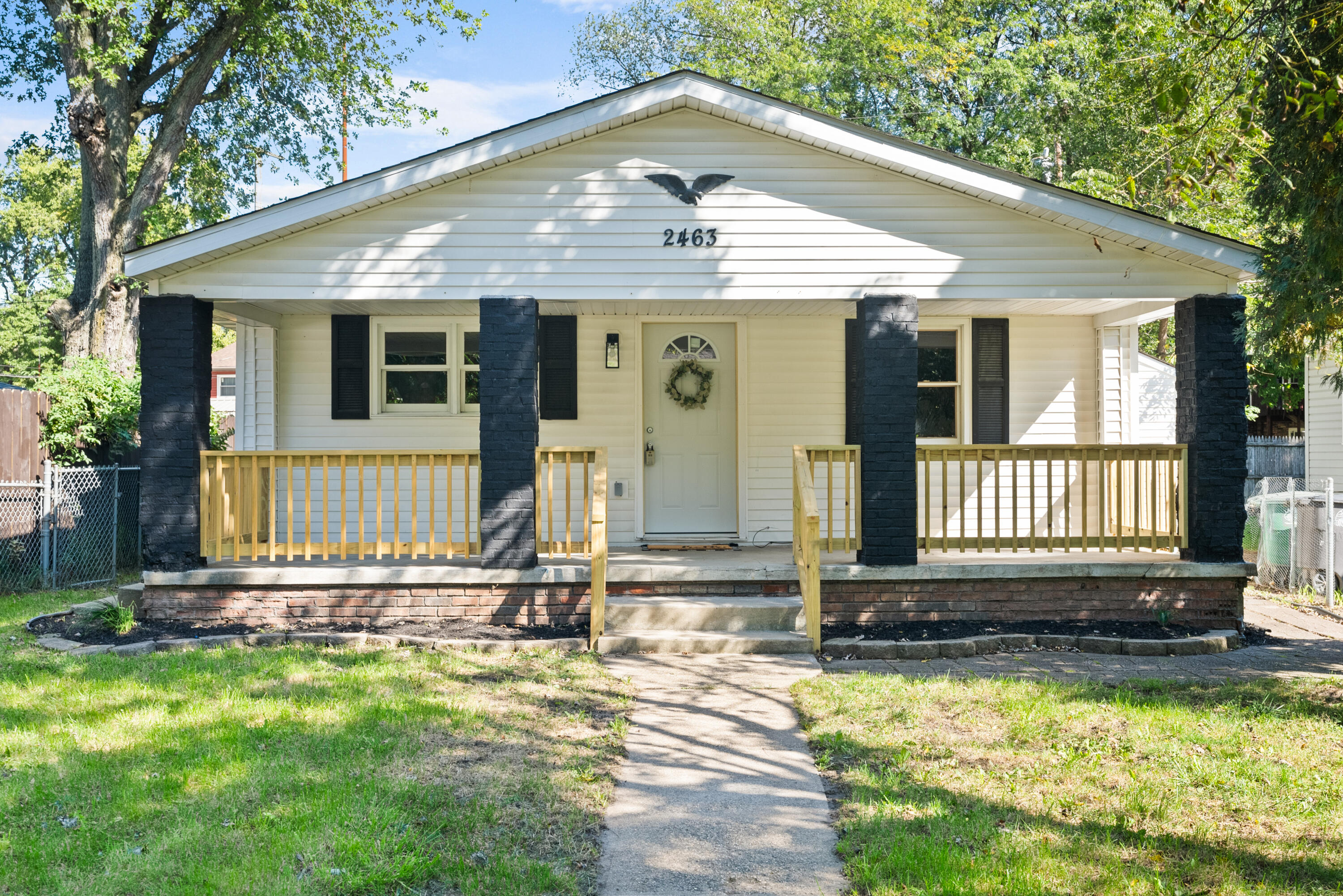 a front view of a house with a yard outdoor seating and garage