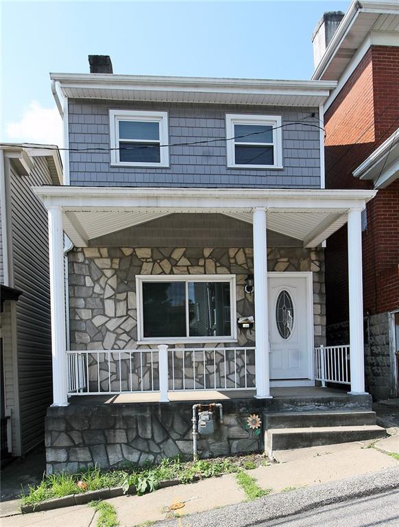 a front view of a house with glass windows and garage