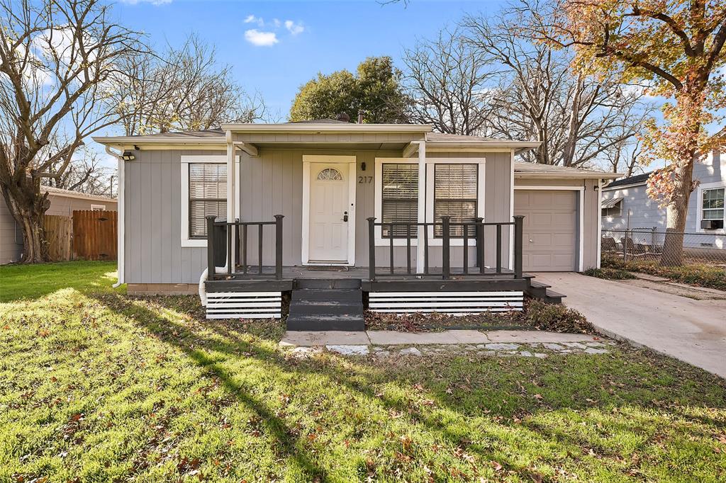 a view of a house with a wooden floor and a yard