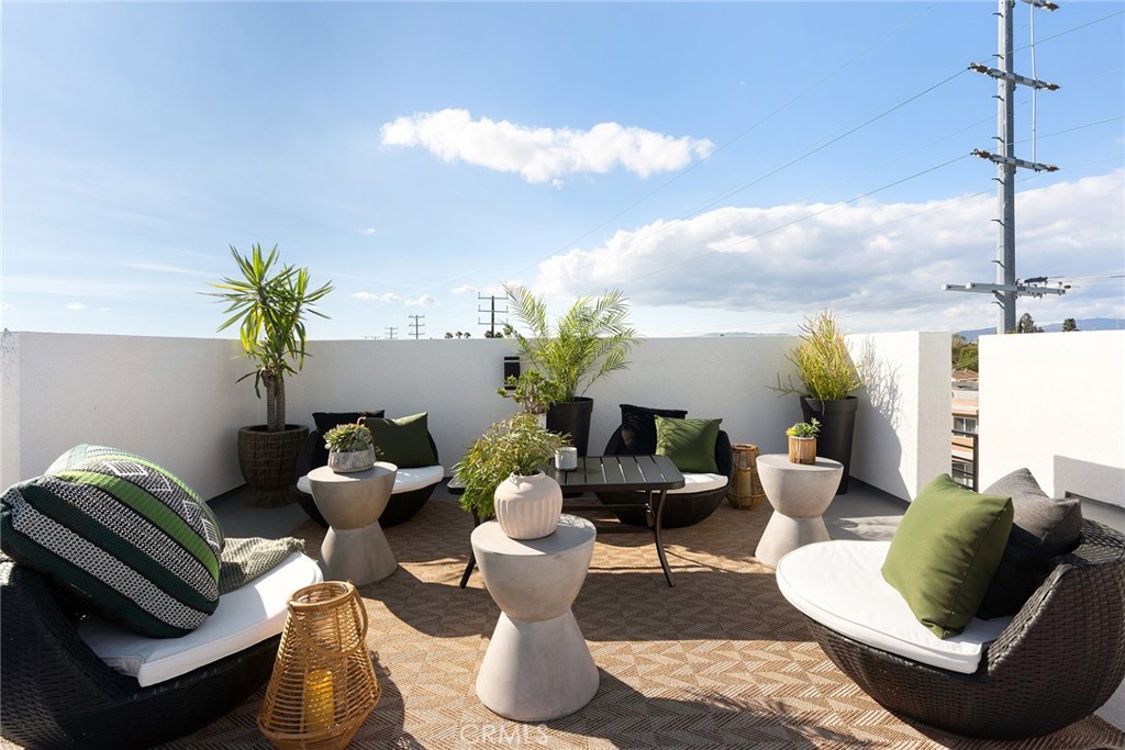 a living room with furniture flowerpot and a potted plant