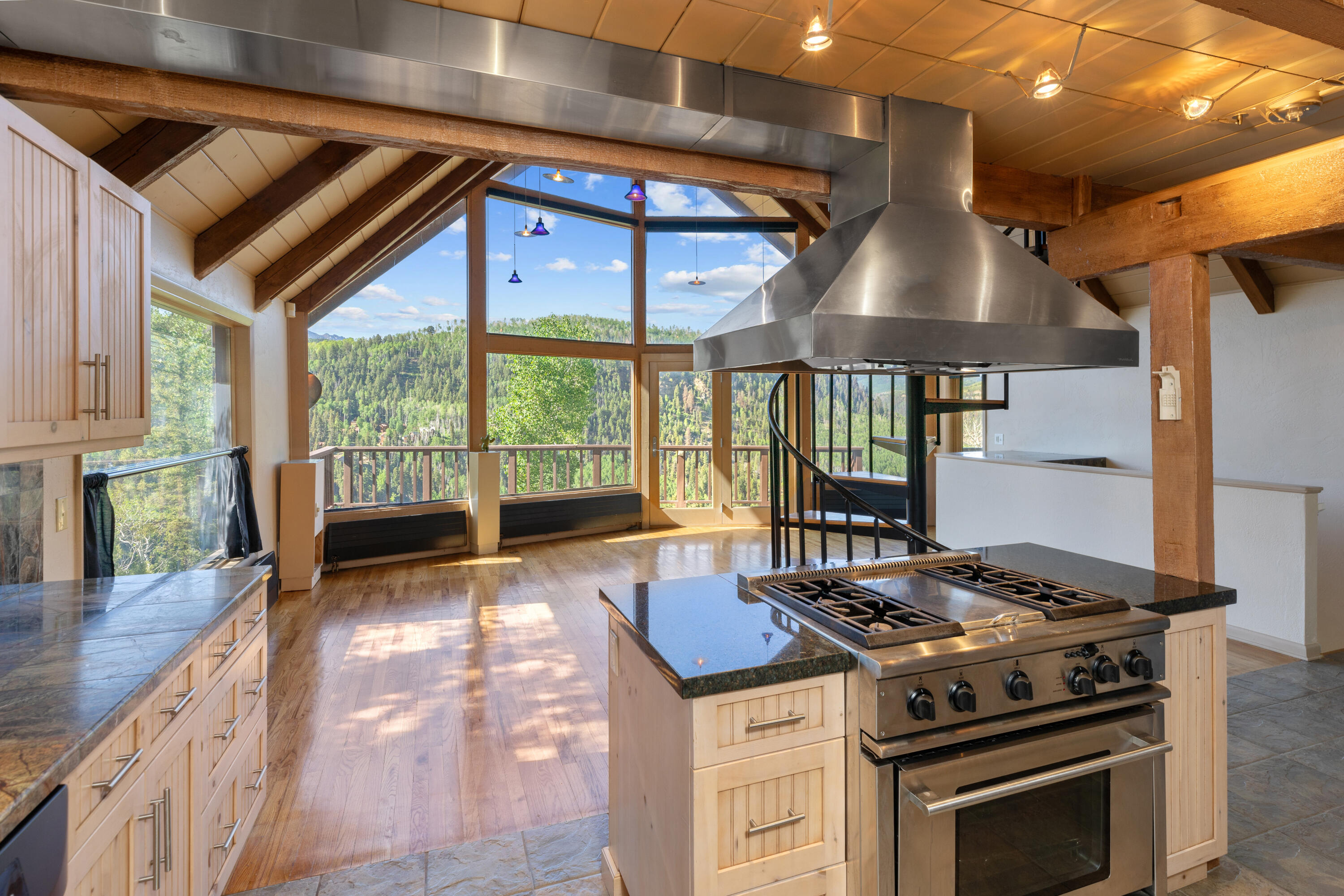 a kitchen with a stove and a wooden floor