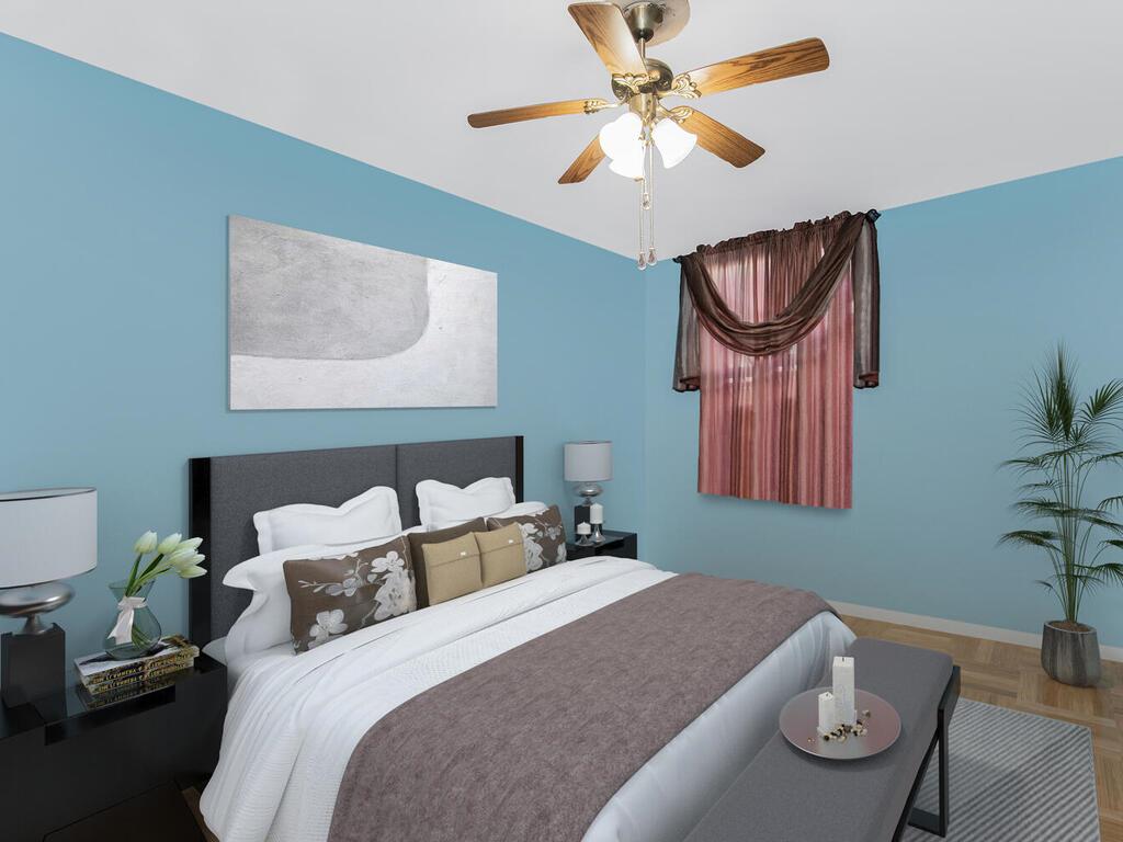 Bedroom with ceiling fan and parquet floors