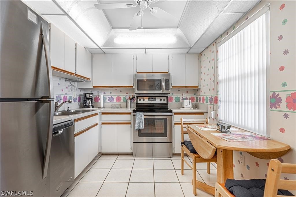 a kitchen with a sink appliances and cabinets