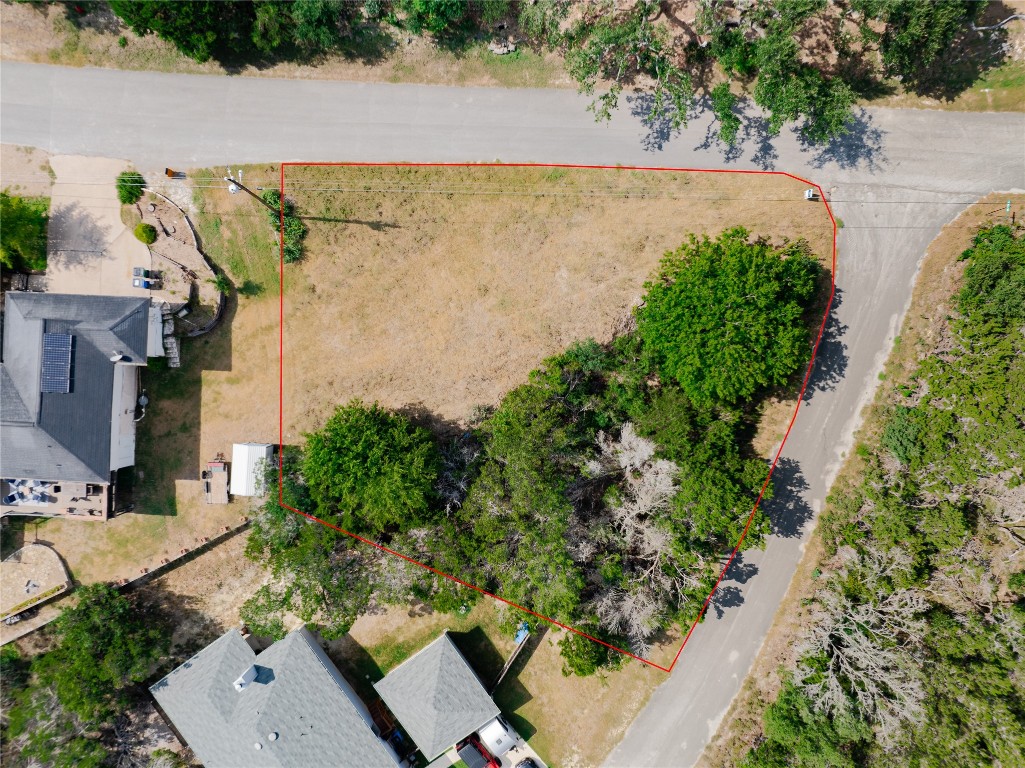 an aerial view of a house with a yard and lake view