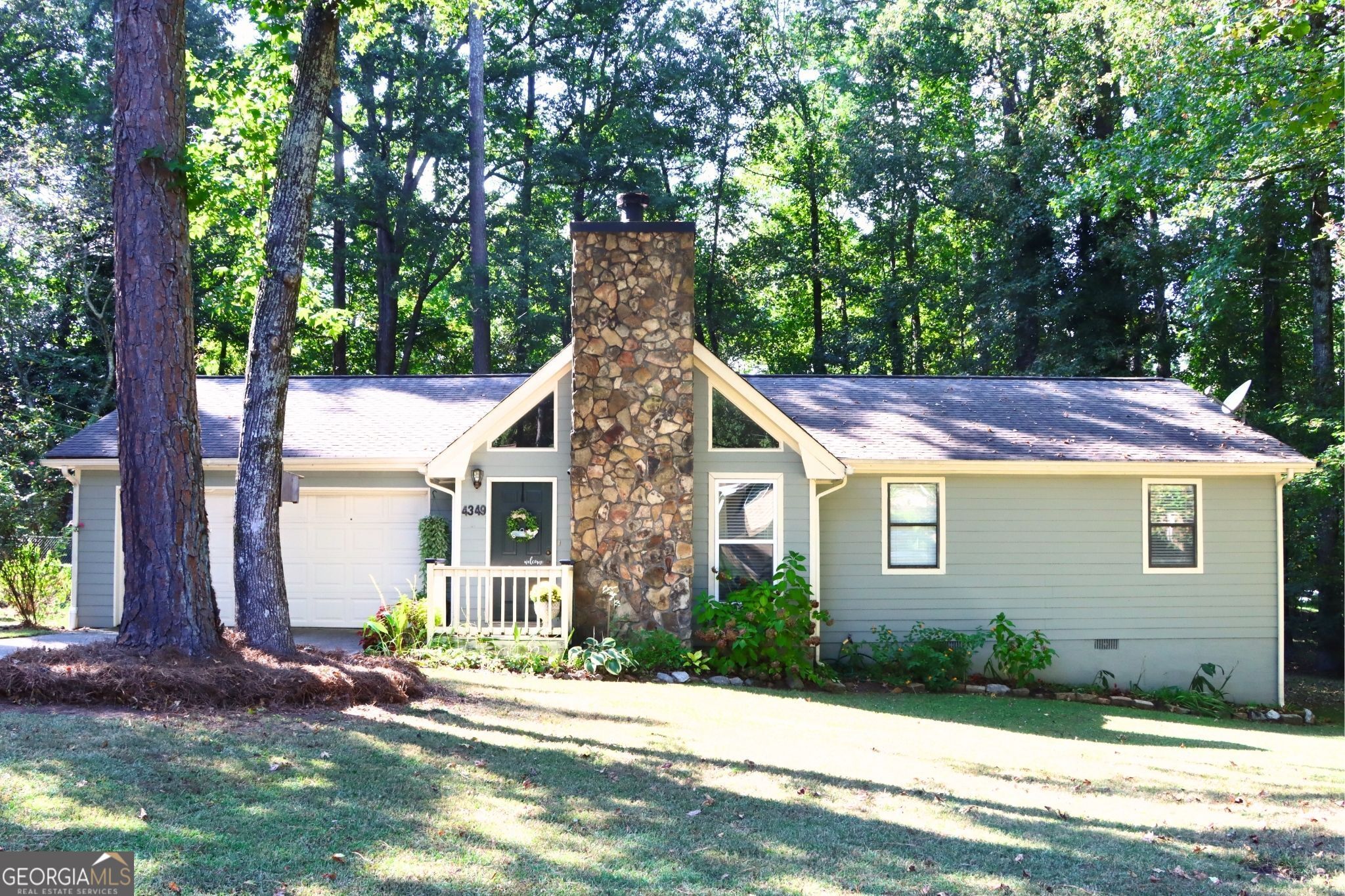 a house that has a tree in front of the house