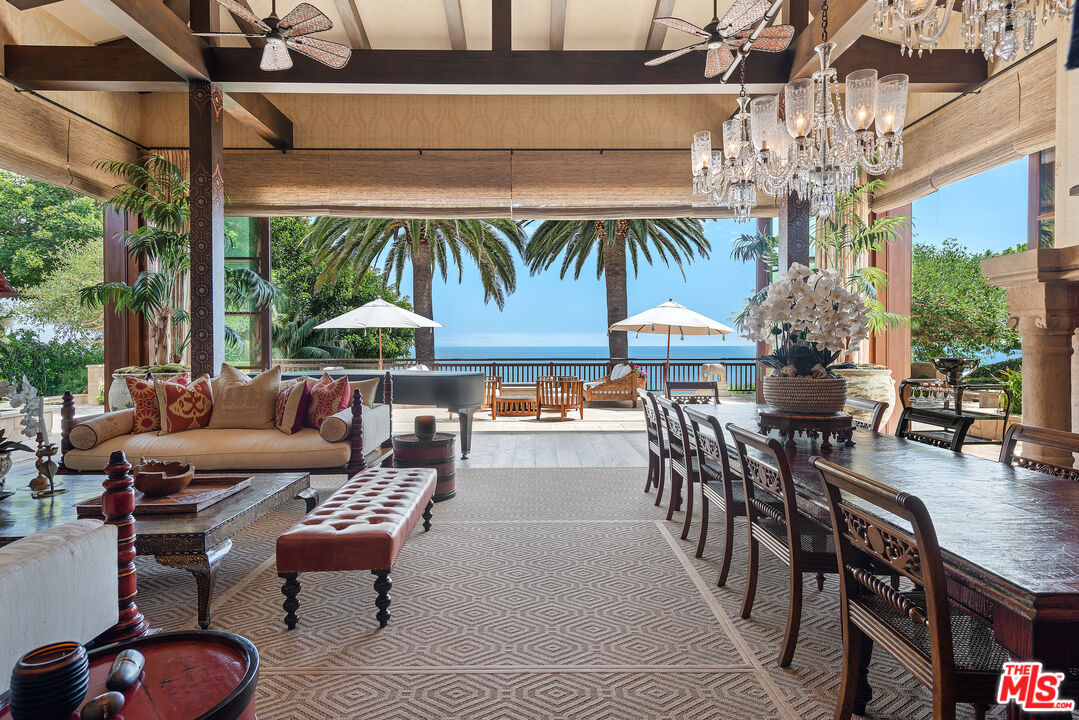 a outdoor living space with furniture and chandelier