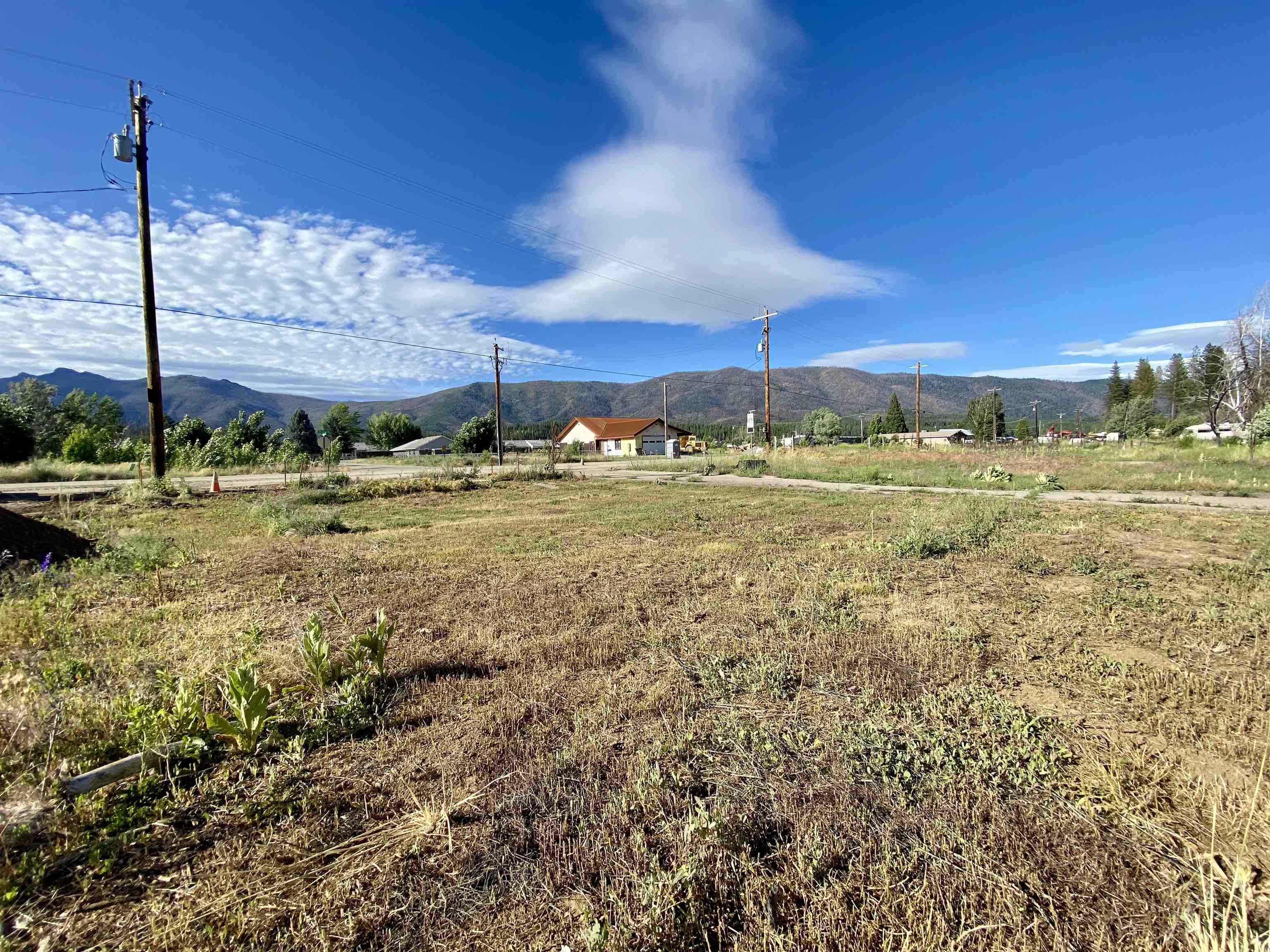 a view of a big yard with swimming pool and mountains