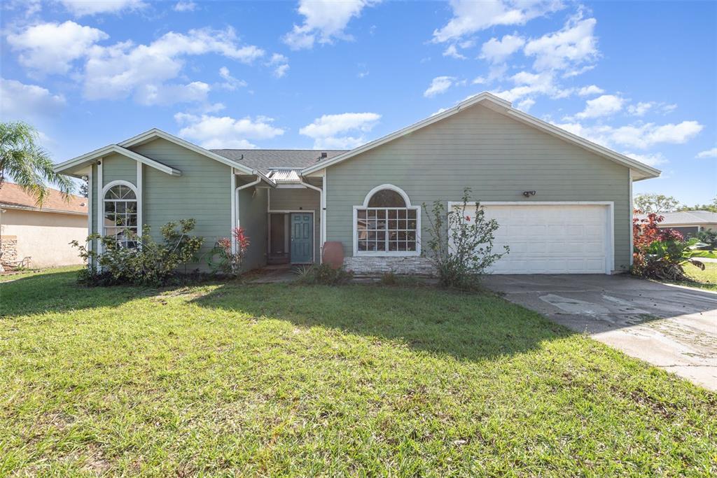 a front view of house with yard and garage