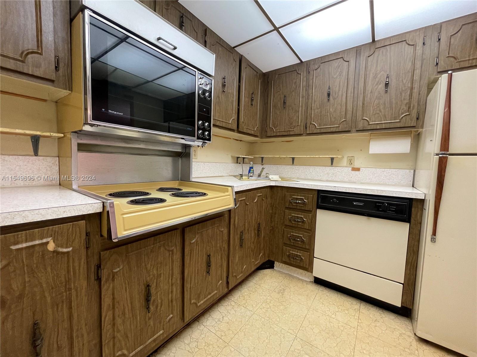 a kitchen with a sink stove and microwave