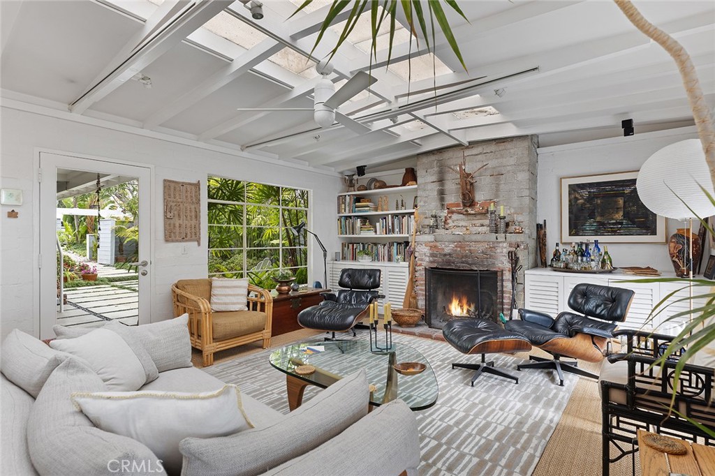 a living room with furniture fireplace and a large window