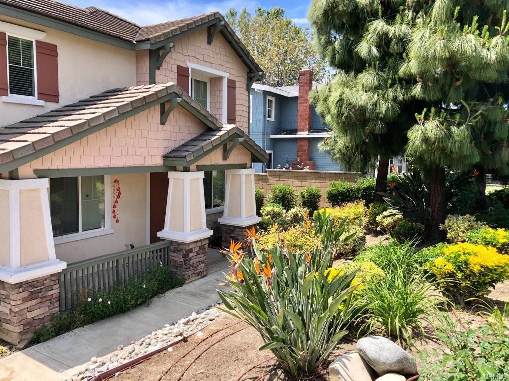 a front view of a house with a yard outdoor seating and mountain view