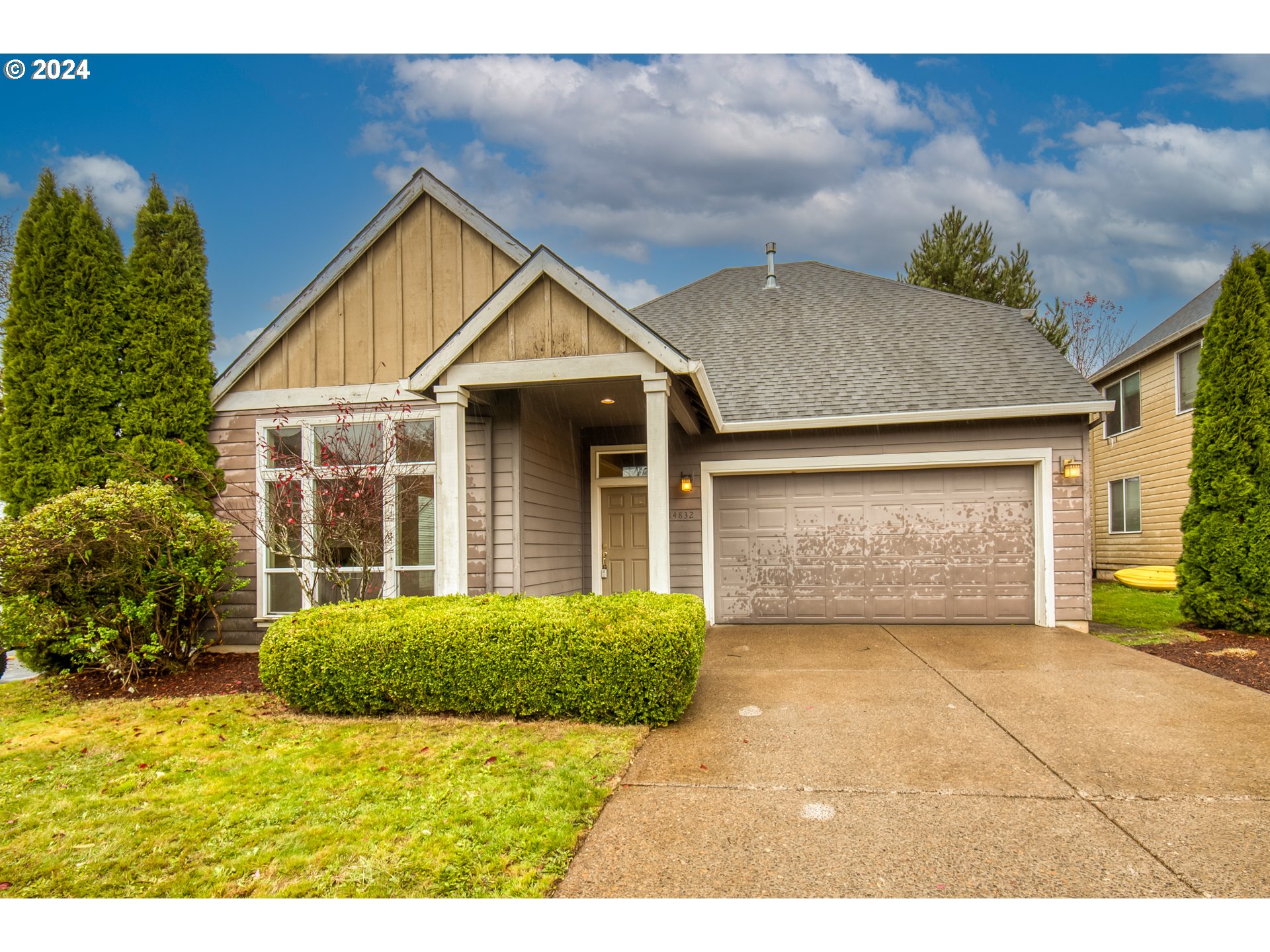 a front view of a house with a yard and garage