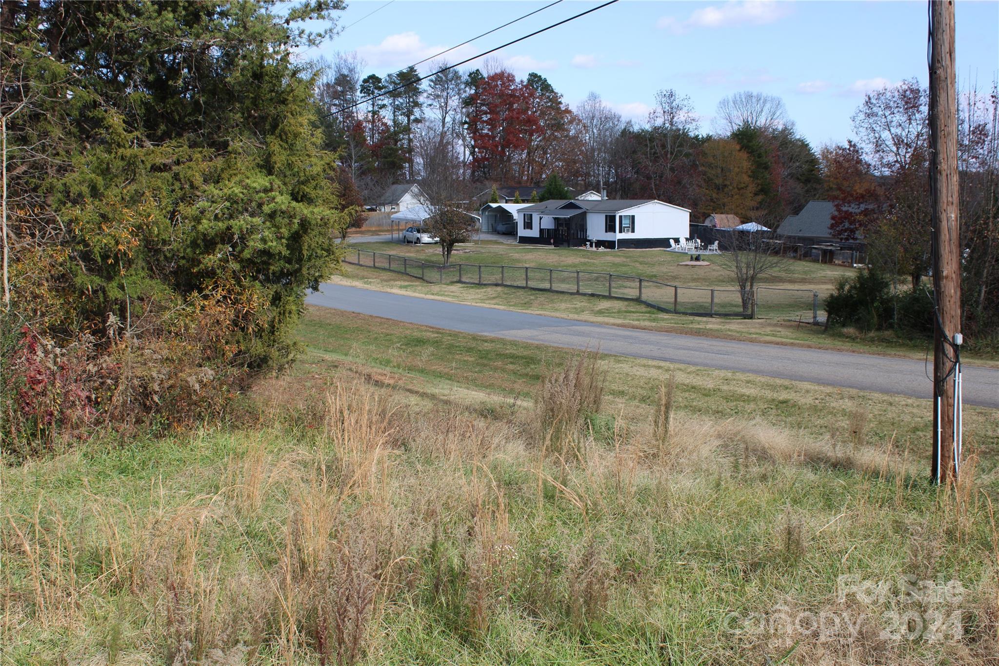 a view of a town with barn house in the background